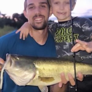 weedless fishing lure worm with father and son and large mouth bass