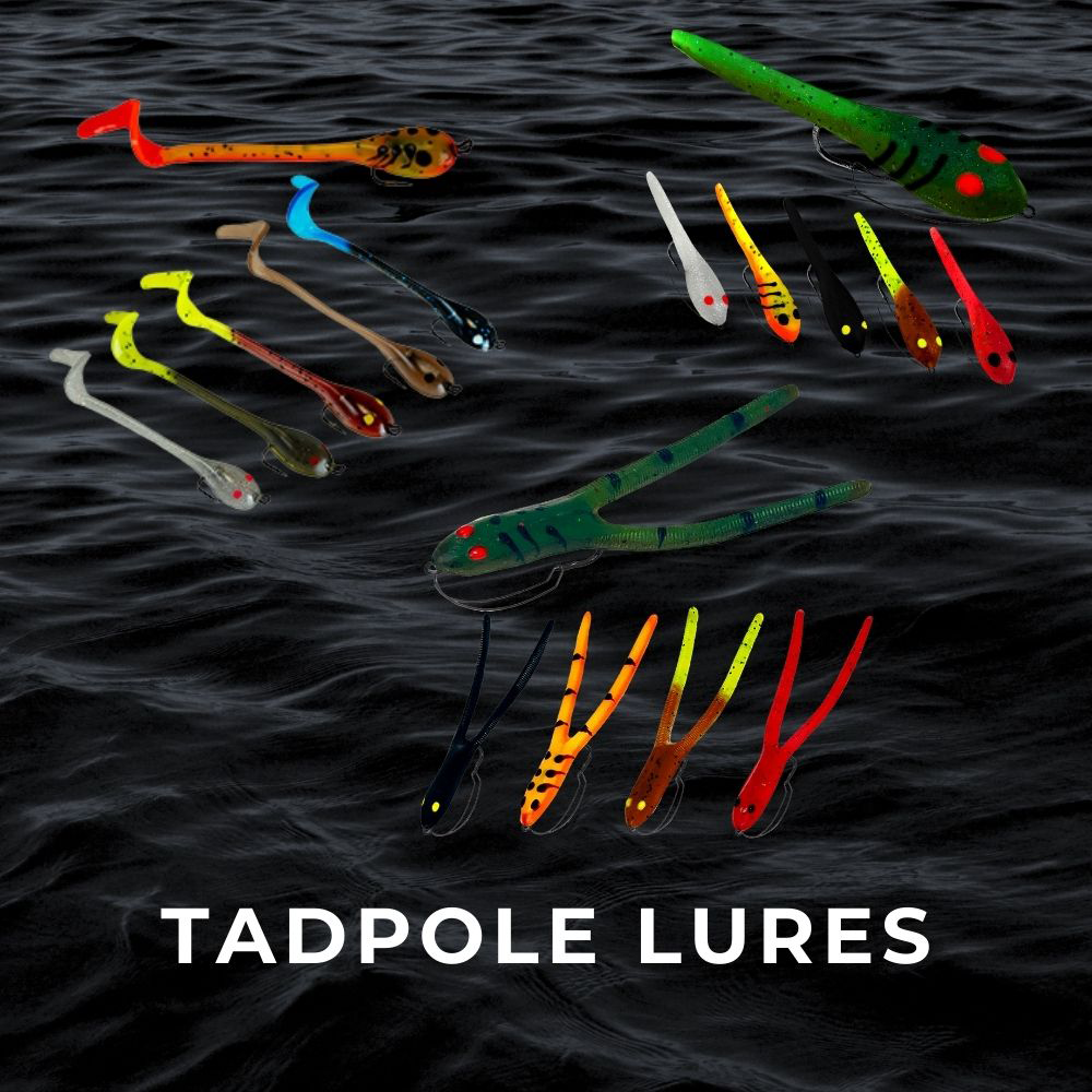 Soft plastic tadpole fishing lures in multiple colors and sizes on dark water background